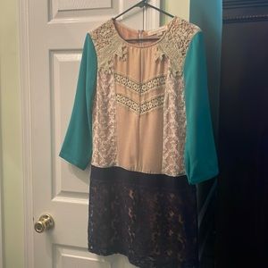 Unique three quarter sleeve dress with lace trim. Boutique!
